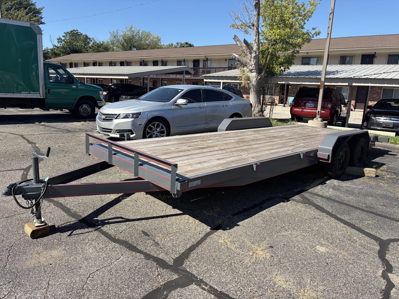 82-inch by 22-foot open car hauler / flatbed trailer, charcoal with red pinstripe and wood deck