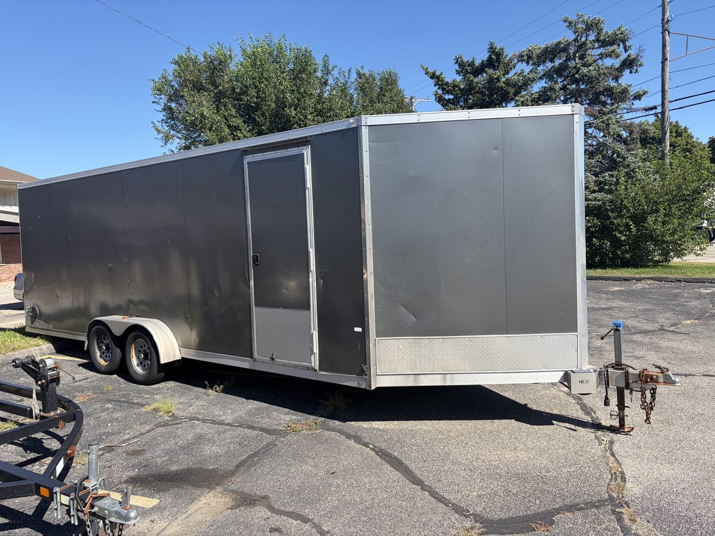NEO enclosed aluminum cargo and car hauler trailer with side man-door